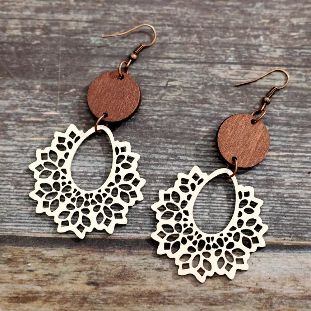 Floral laser-cut wooden drop earrings in ivory with tan wood accents.