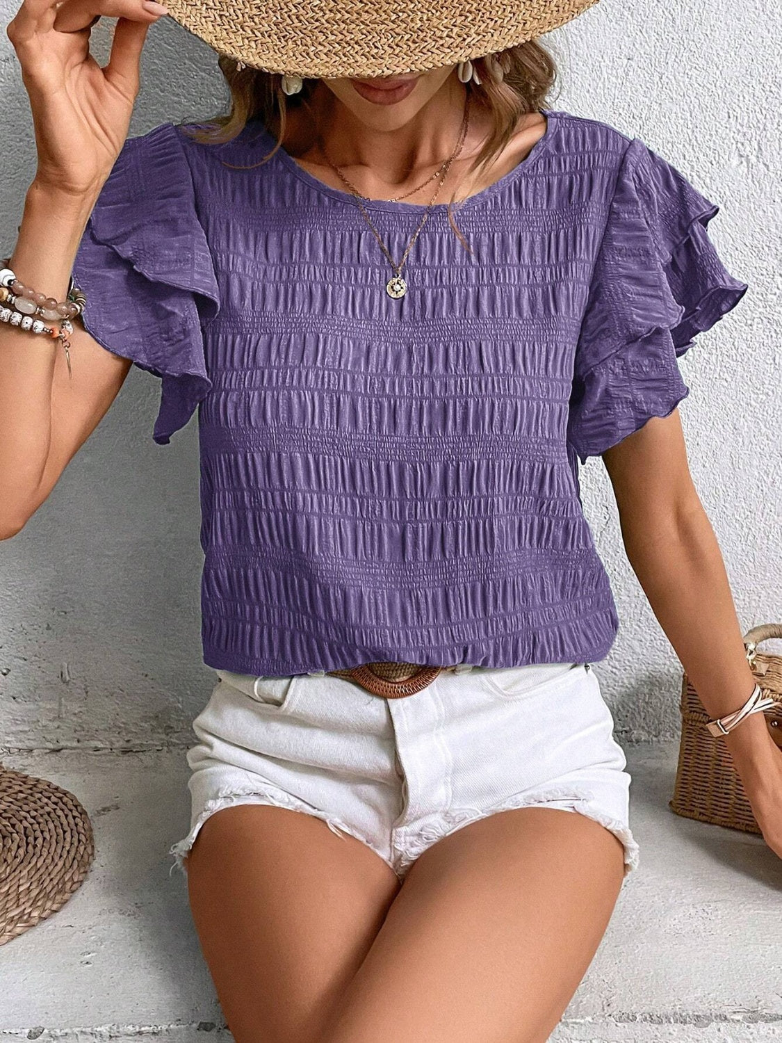 Textured ruffle sleeve smocked top in purple, 100% polyester, with a round neckline.