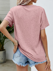 Blush Pink graphic tee with short sleeves and a relaxed fit, paired with denim shorts.
