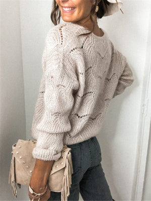 Beige scalloped knit cardigan with openwork pattern and balloon sleeves.