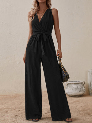 Black textured wrap-front wide-leg jumpsuit with tie waist and V-neck.