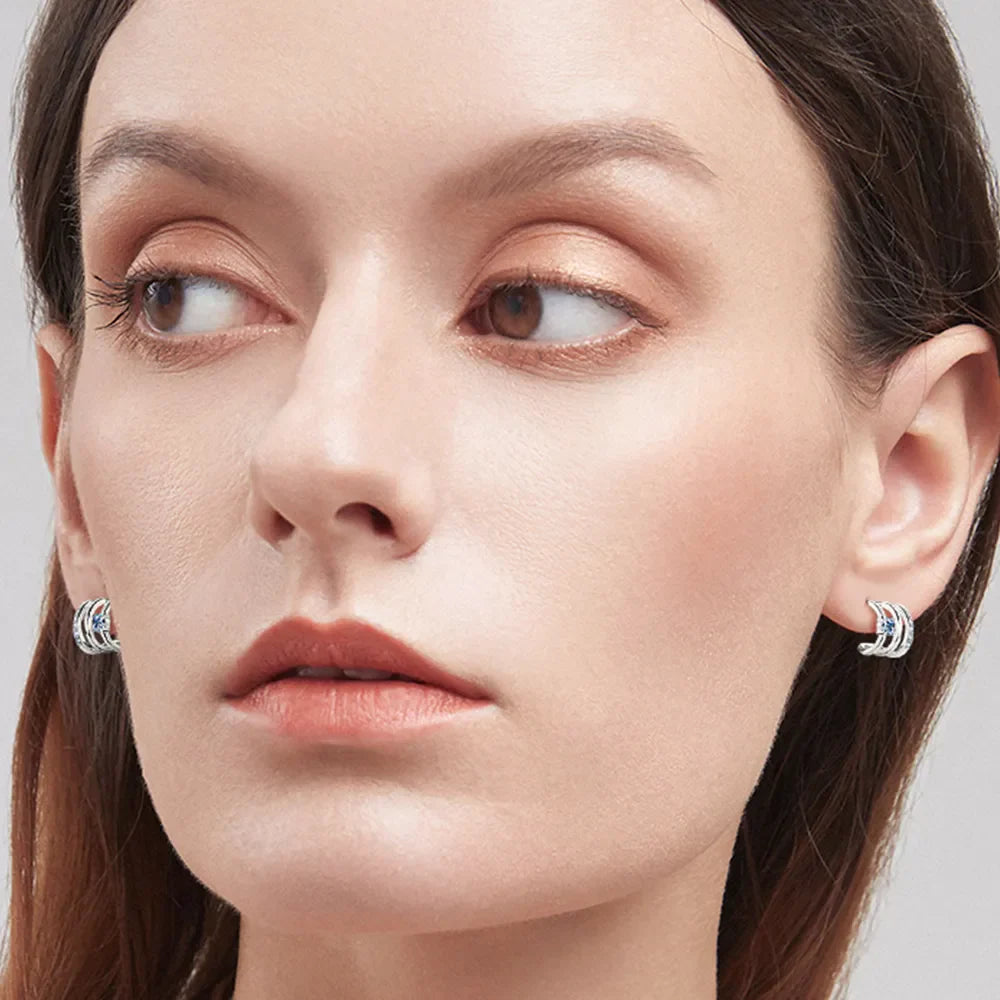 Silver triple-bar stud earrings with blue crystals, D color grade, for women.