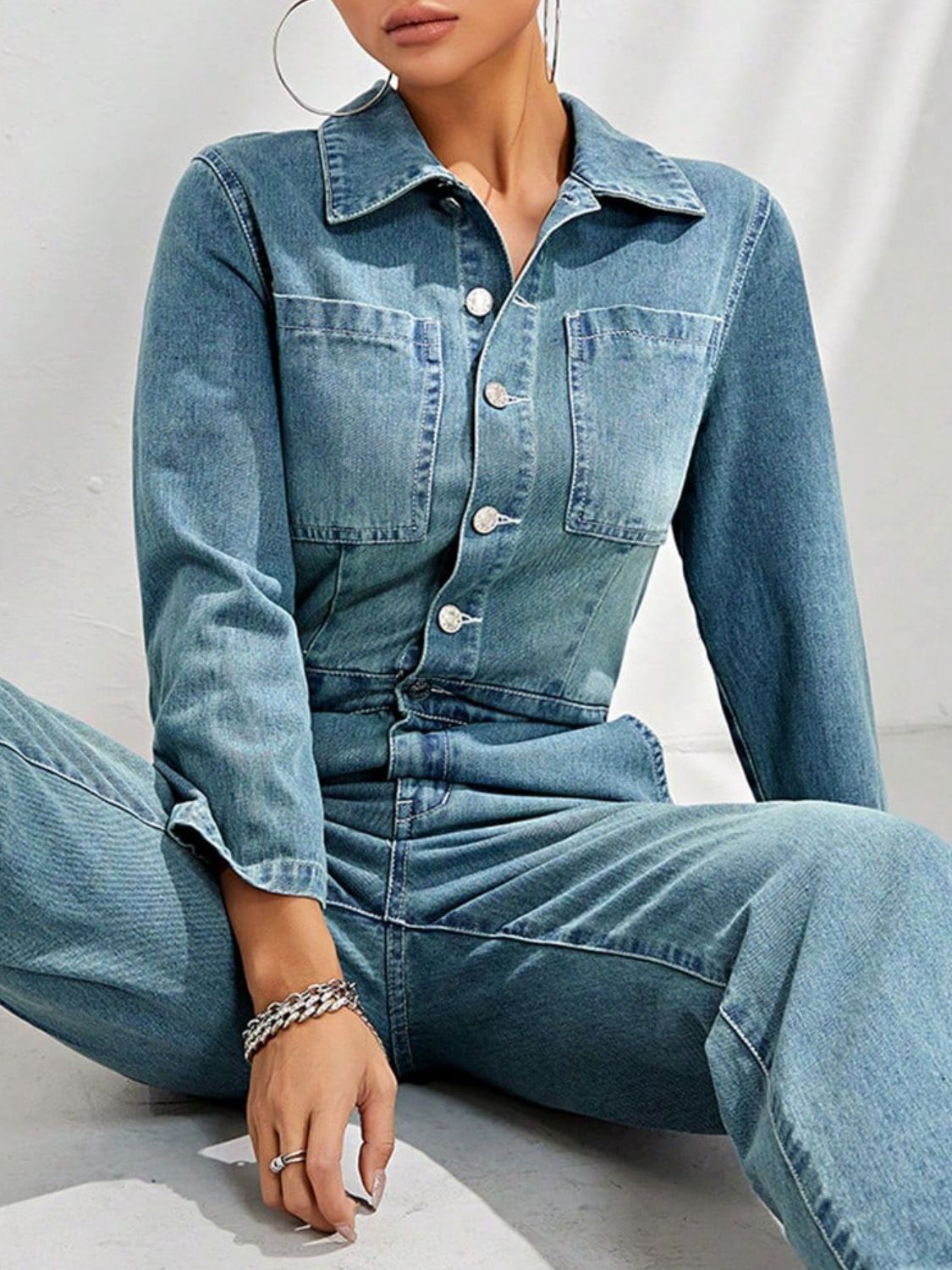 Structured light denim boiler suit with button front and chest pockets.
