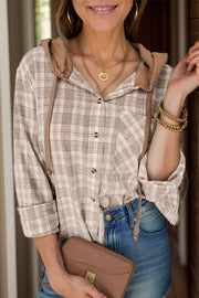 Plaid hooded shirt jacket in khaki with drawstring details and button front.