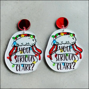 Holiday graphic acrylic statement earrings with Christmas lights and text.