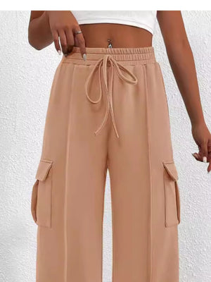 Apricot high waist cargo pants with drawstring and side pockets.