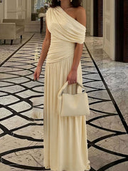 Elegant beige one-shoulder maxi dress with draped bodice and ruching.