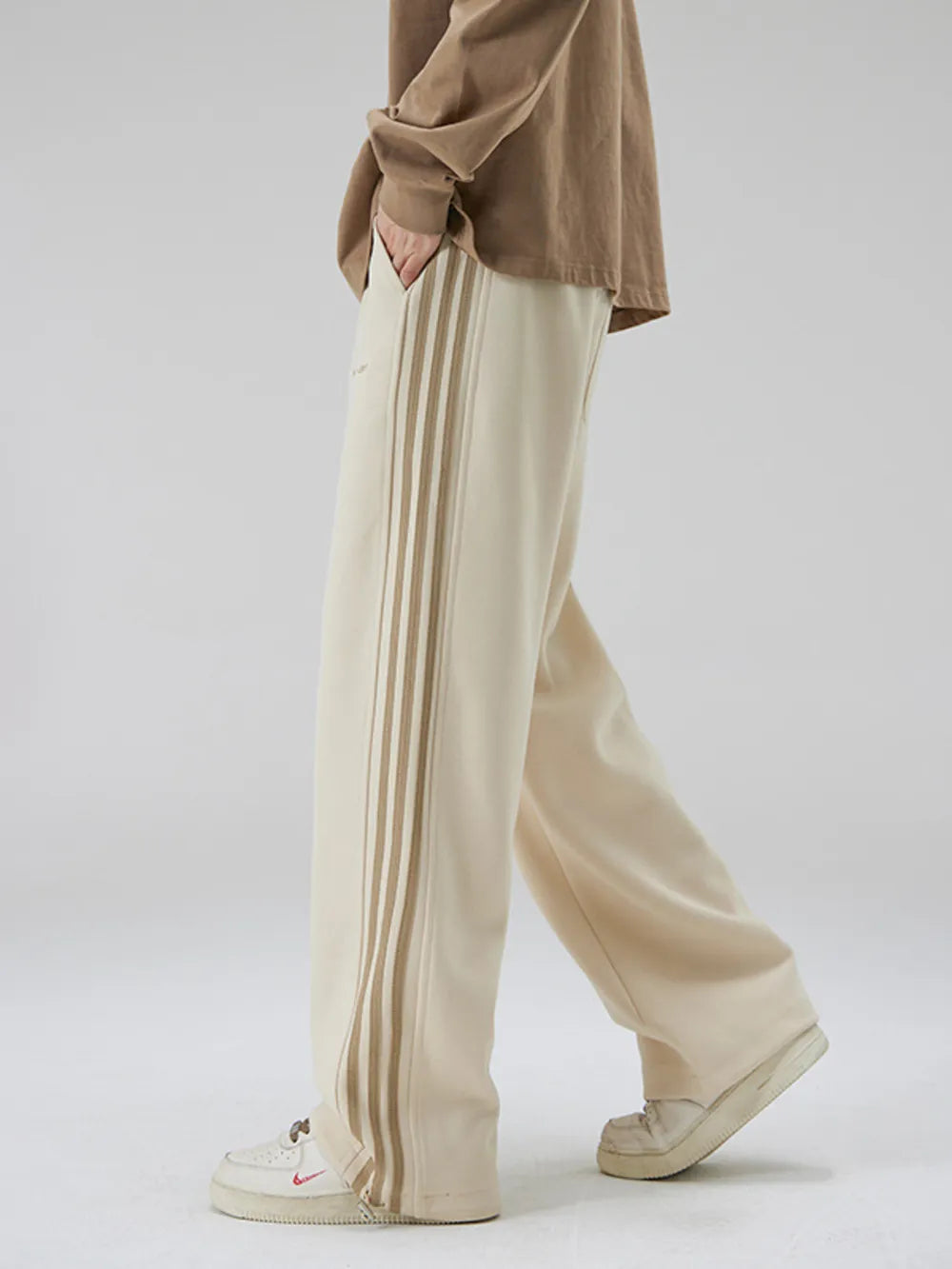 Khaki sweatpants with vertical stripe detail and wide leg cut.