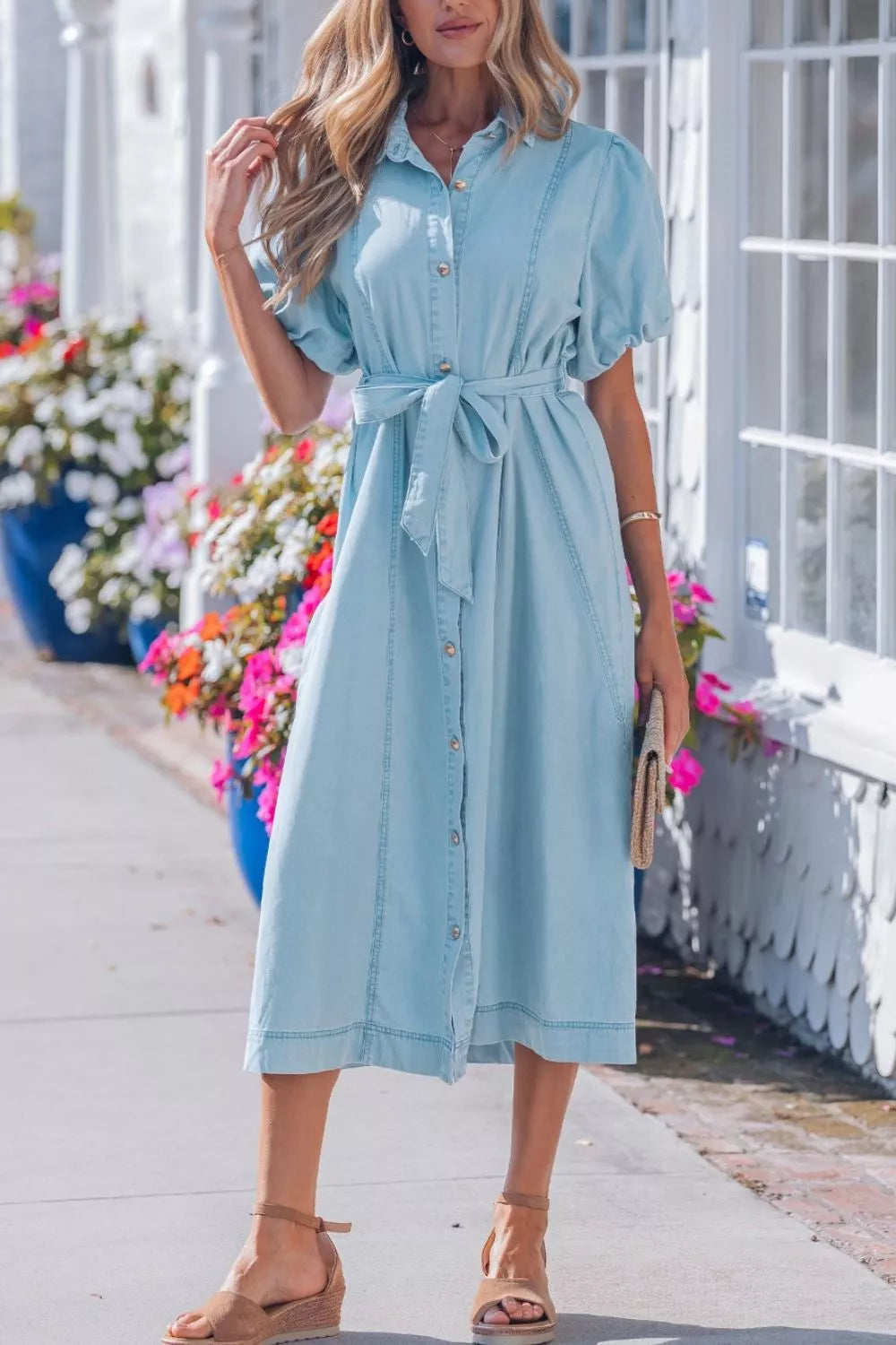 Light blue denim midi dress with collar, short puff sleeves, button front, and tie belt.