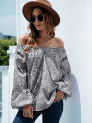 Off-the-shoulder black spotted print blouson top with balloon sleeves.