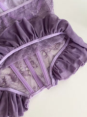 Purple lace bustier top with ruffled mesh trim and boning detail.