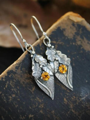 Textured leaf citrine drop earrings with yellow gemstones and silver alloy.