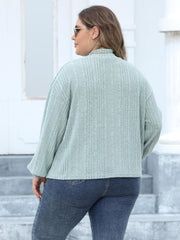 Textured mock neck sweater in Gum Leaf with balloon sleeves and ribbed knit detail.