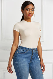 Ivory crew neck short sleeve bodysuit with a smooth finish.
