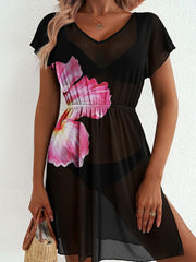 Black sheer mini dress with pink floral print, V-neck, short sleeves, and side slit.
