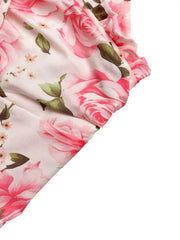 Romantic floral halter midi dress with pink roses and ruffled trim.