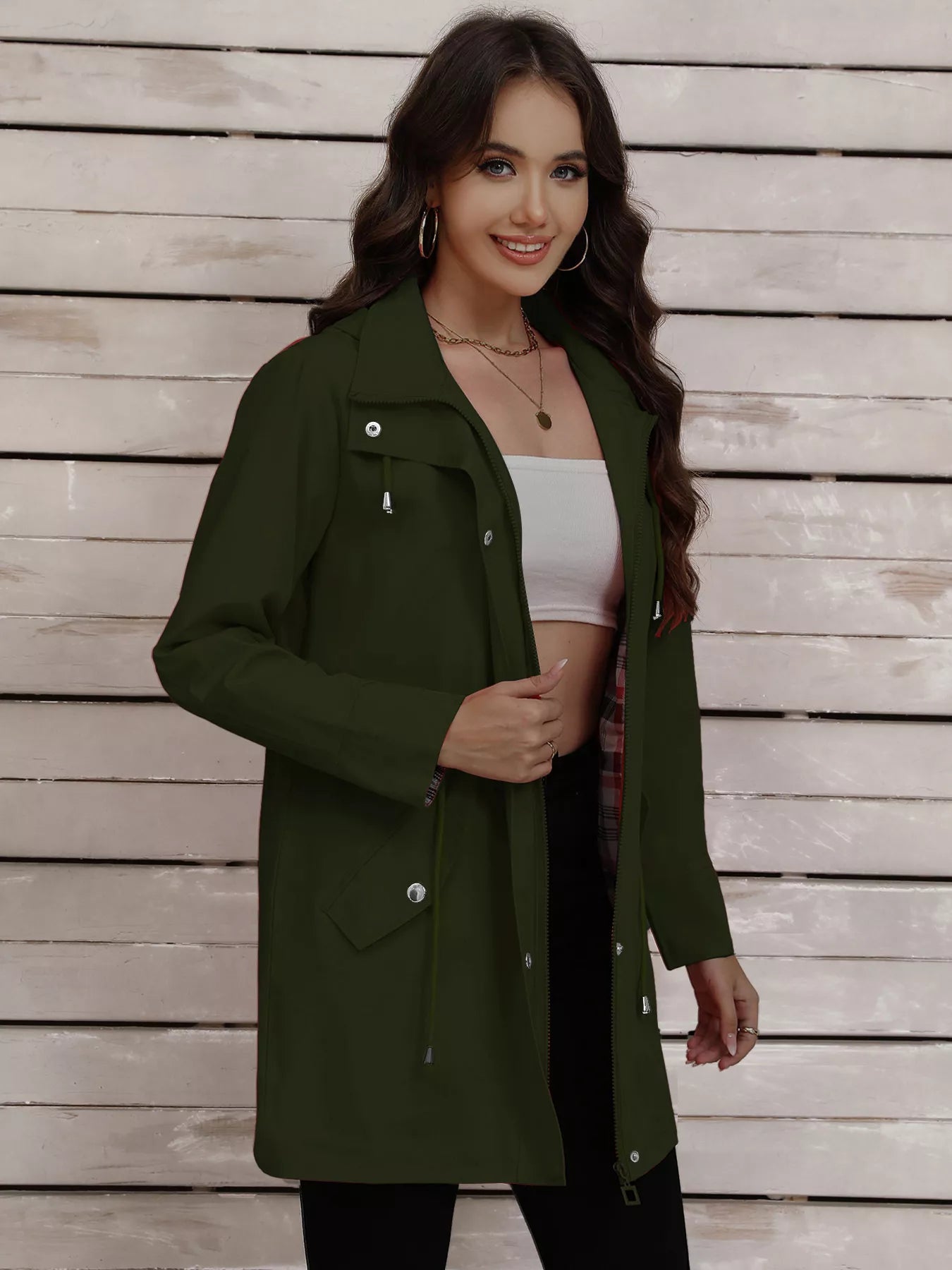 Military green drawstring trench coat with snap-down details and a plaid lining.