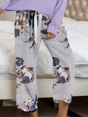 Botanical print lounge pants in grey with a drawstring waist and relaxed fit.