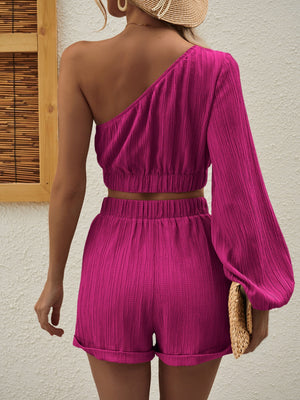 Textured one-shoulder crop top and cuffed shorts set in bright pink.