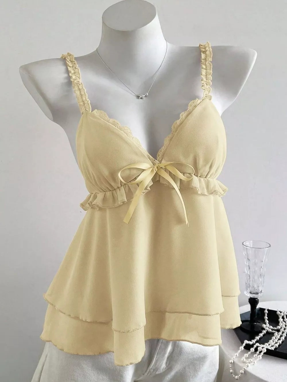 Light yellow layered cami with lace trim and bow detail
