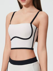 White crop top with black trim and spaghetti straps, sculpted bust detail