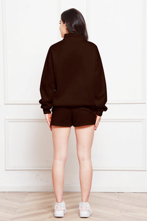 Quarter-zip loungewear set in chocolate brown, featuring a mock neck sweatshirt and matching shorts.