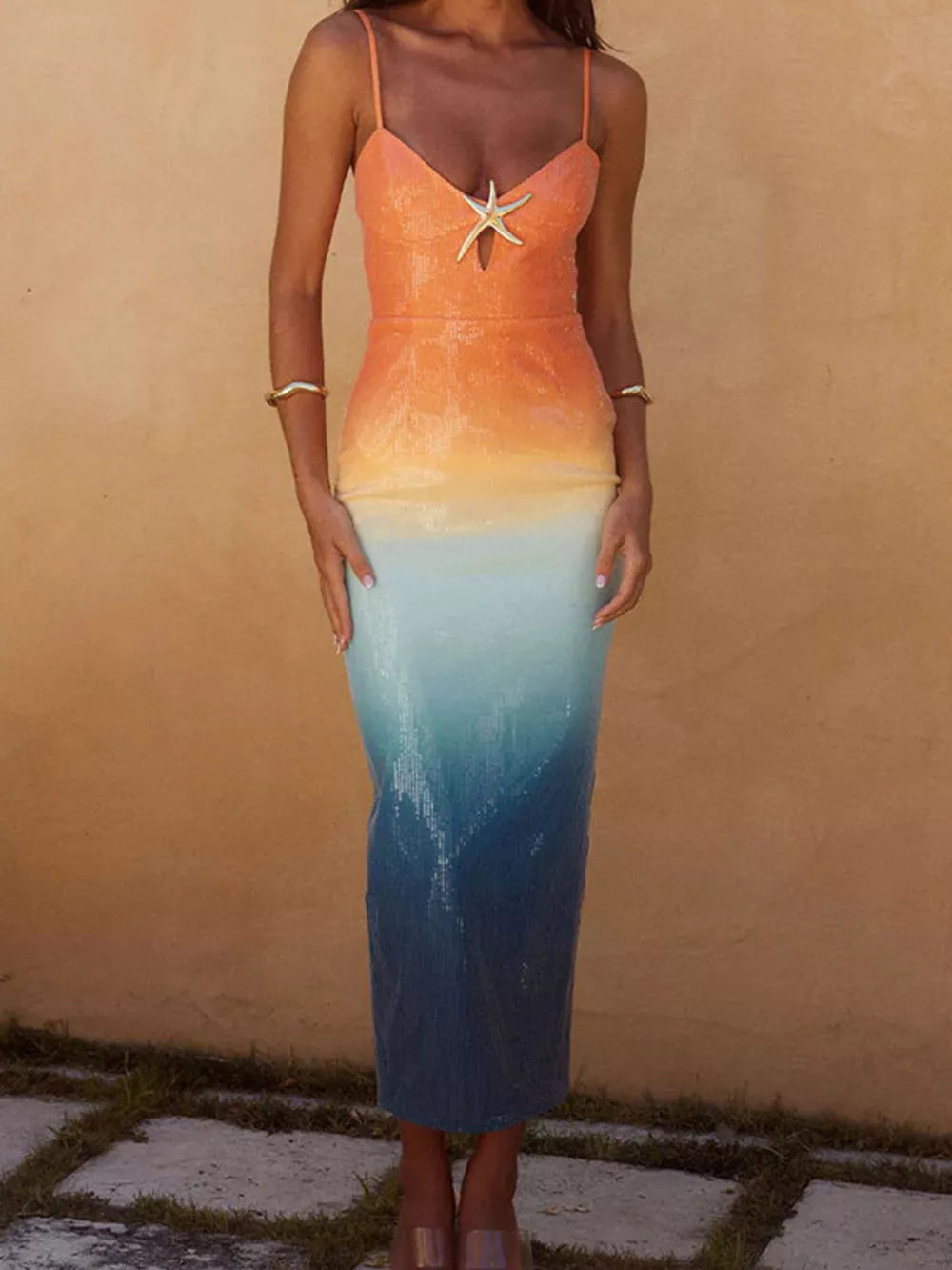 Sequined cami dress with starfish detail and orange to blue gradient.