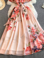 Botanical off-shoulder dress in light pink with a floral print and a bow detail.