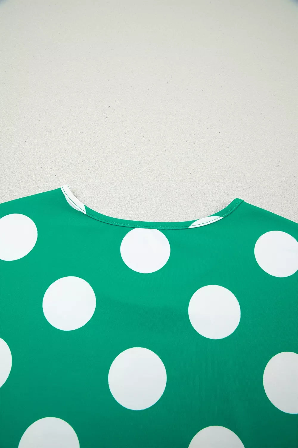 Green polka dot cropped tee with white polka dots and a crew neck.