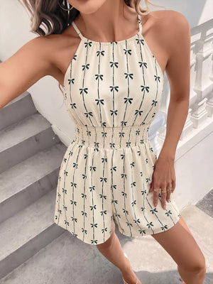 Charming Bow Print Smocked Halter Romper in apricot with a bow print and smocked waist.