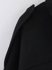 Black oversized zip-up jacket with a sharp collar detail.