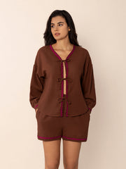 Brown linen tie-front pajama set with scallop trim and bow details.