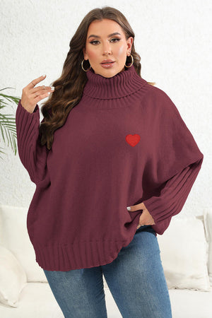 Wine turtleneck sweater with batwing sleeves and red heart appliqué detail.