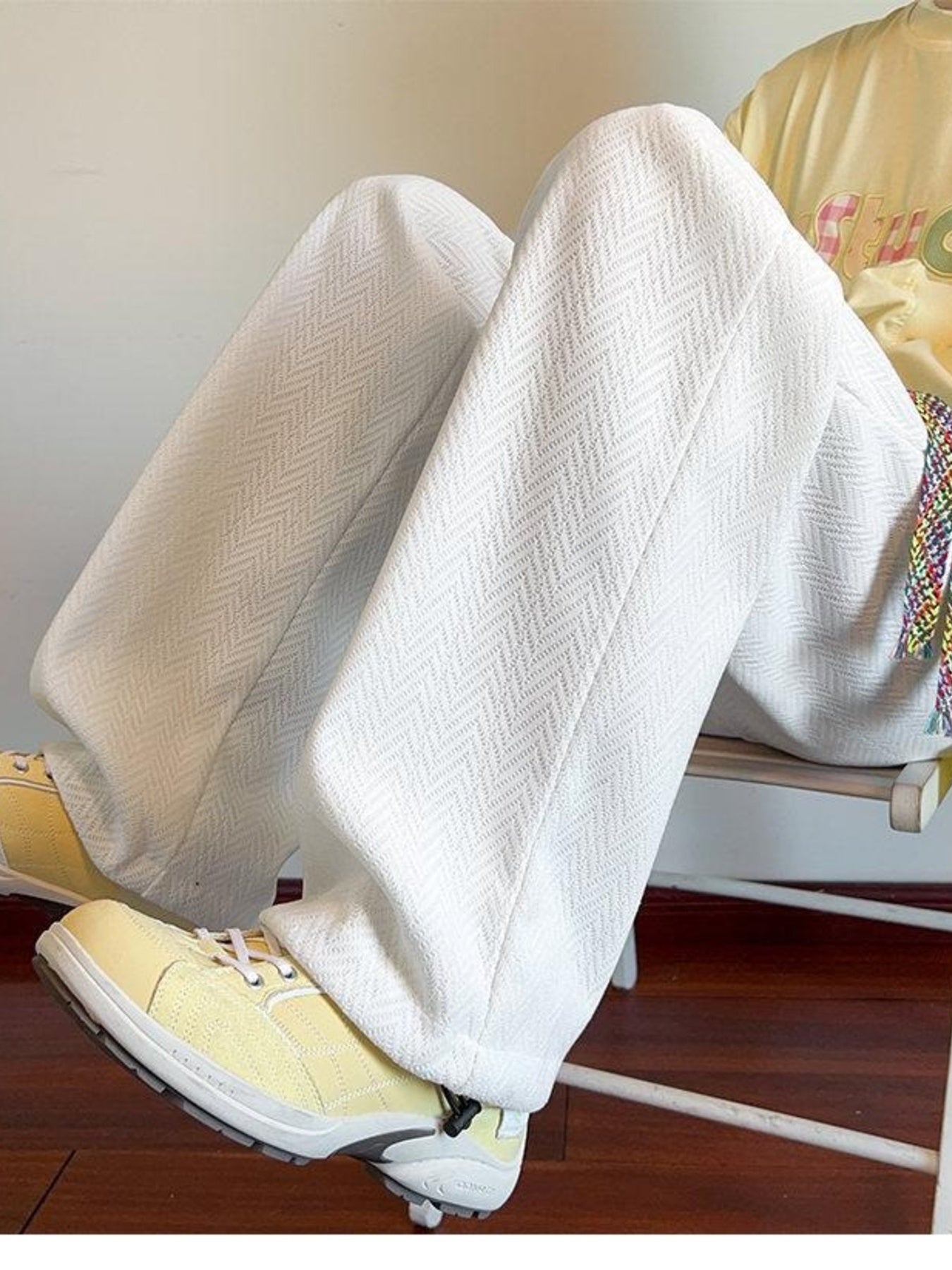 Men's white textured wide leg sweatpants with herringbone pattern and drawstring.