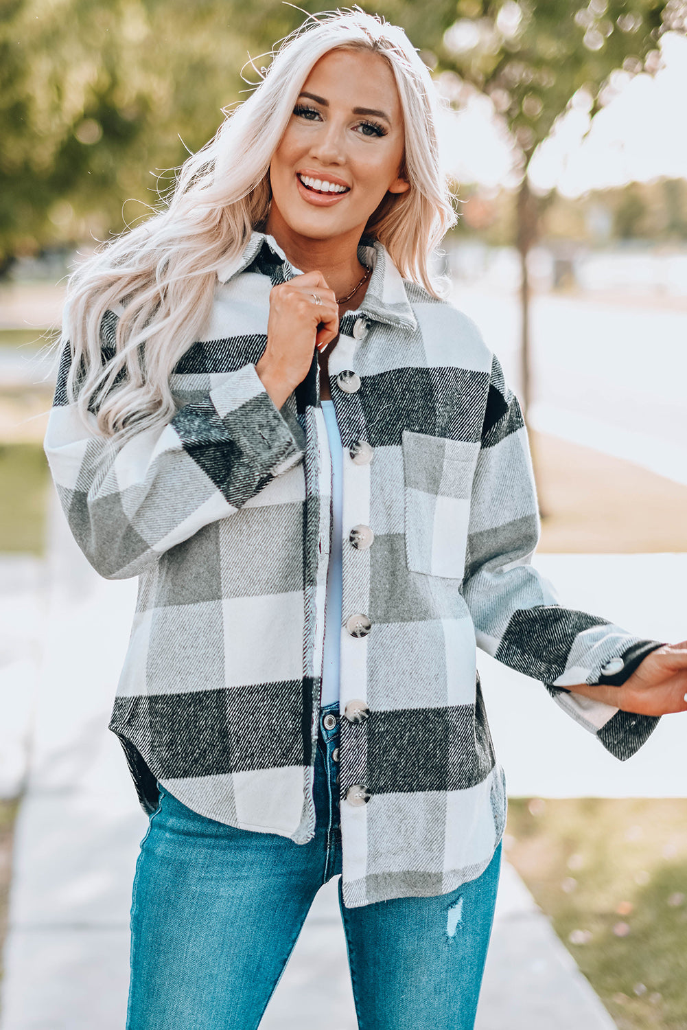 Oversized checkered shacket in black and white with button-down front and patch pocket.