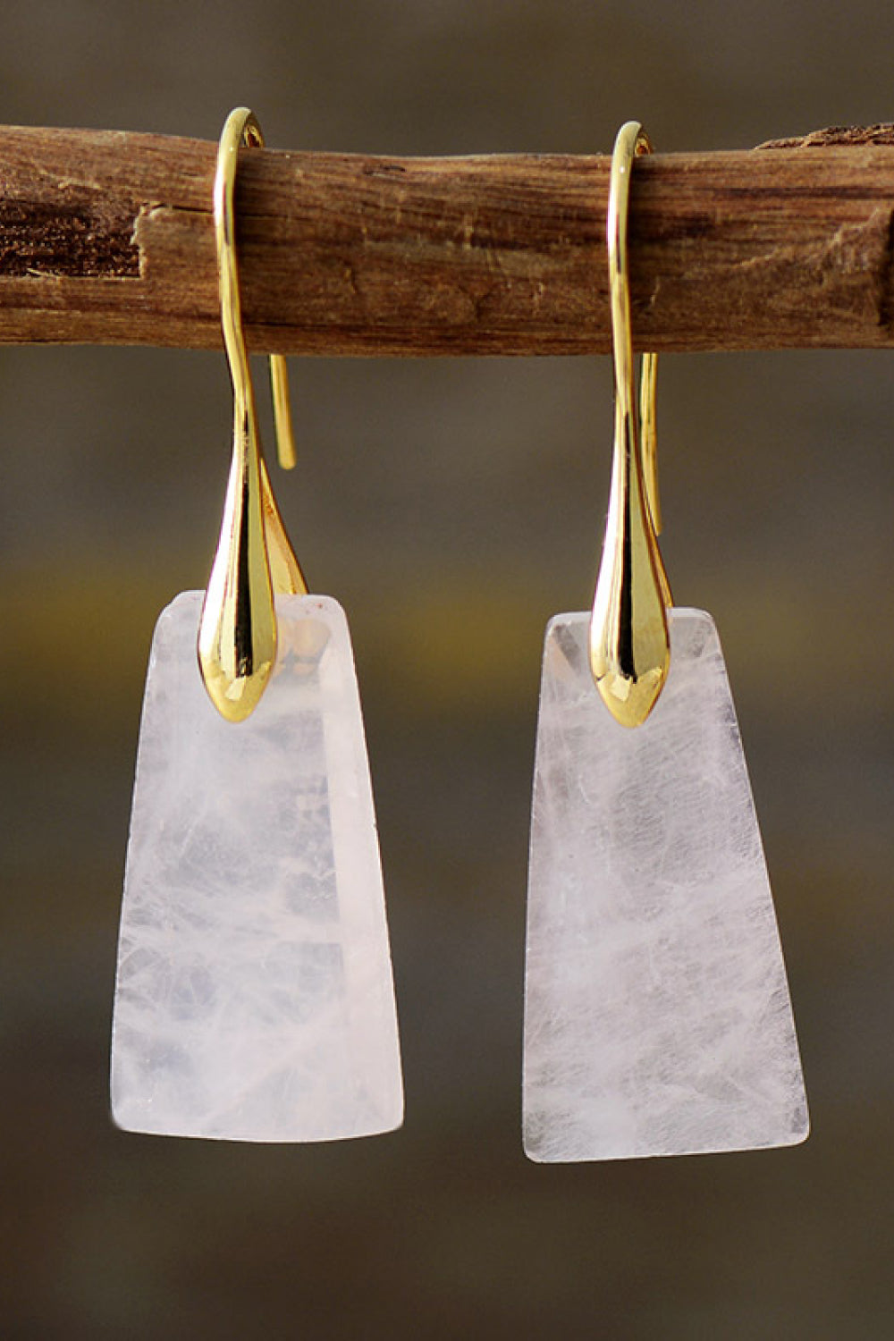 Trapezoid drop earrings with gold hooks and pale pink stones.