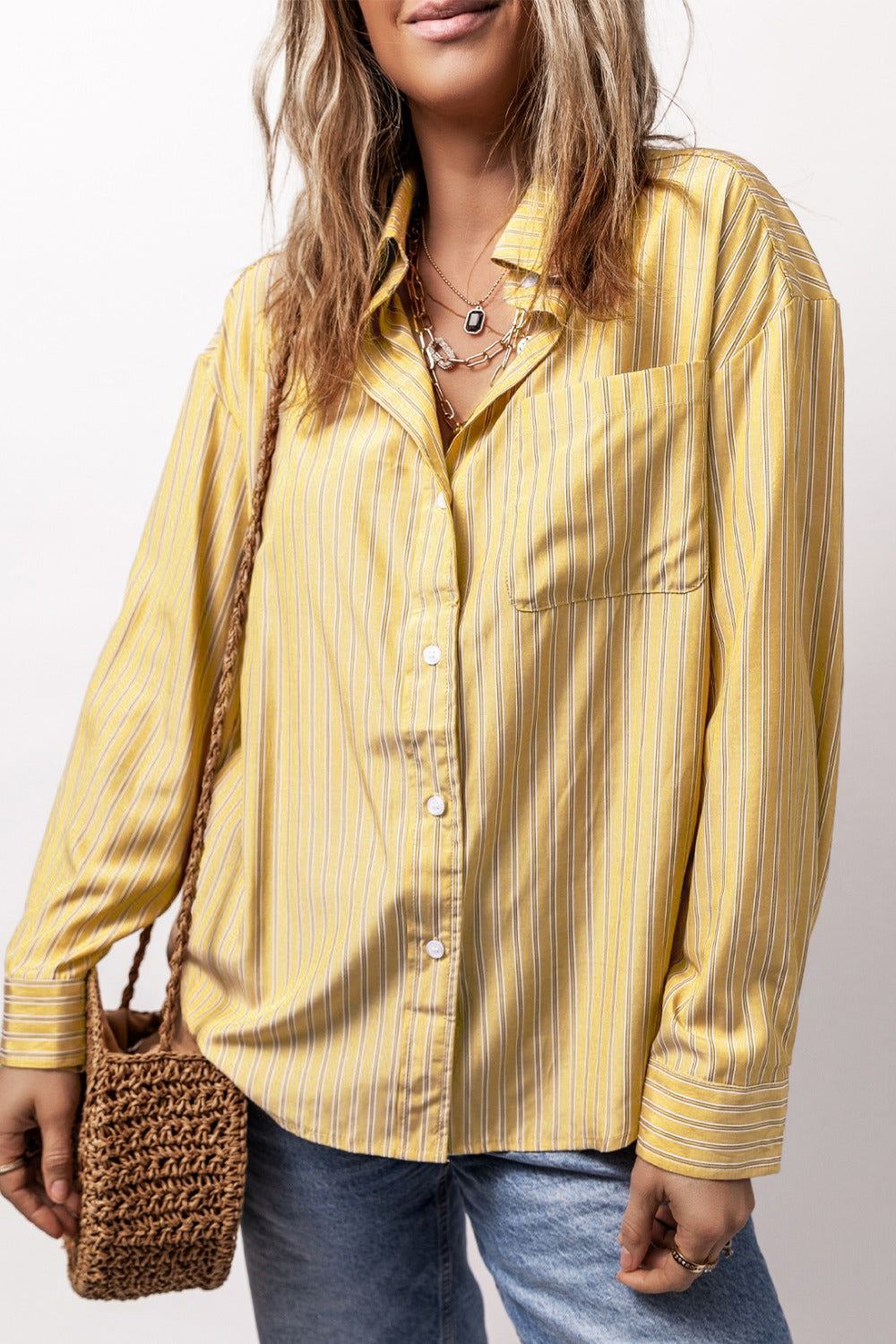 Oversized pastel yellow stripe oxford shirt with button front and chest pocket.