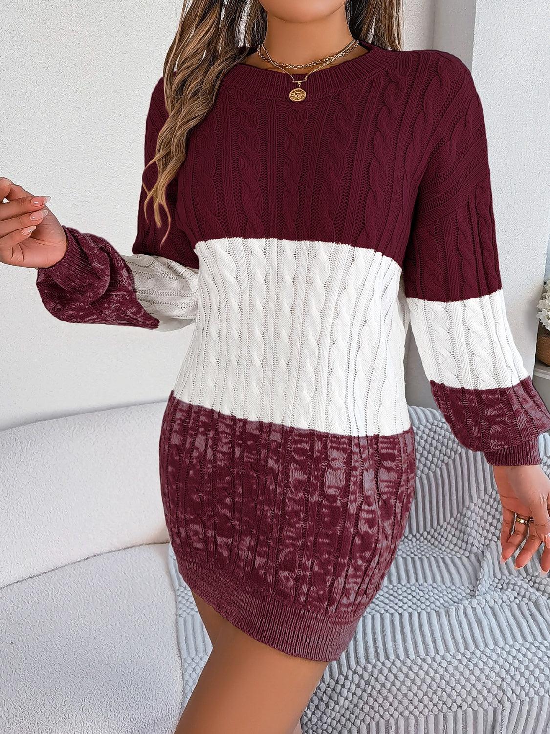 Colorblock cable knit mini dress in burgundy and white acrylic with crew neck and long sleeves.