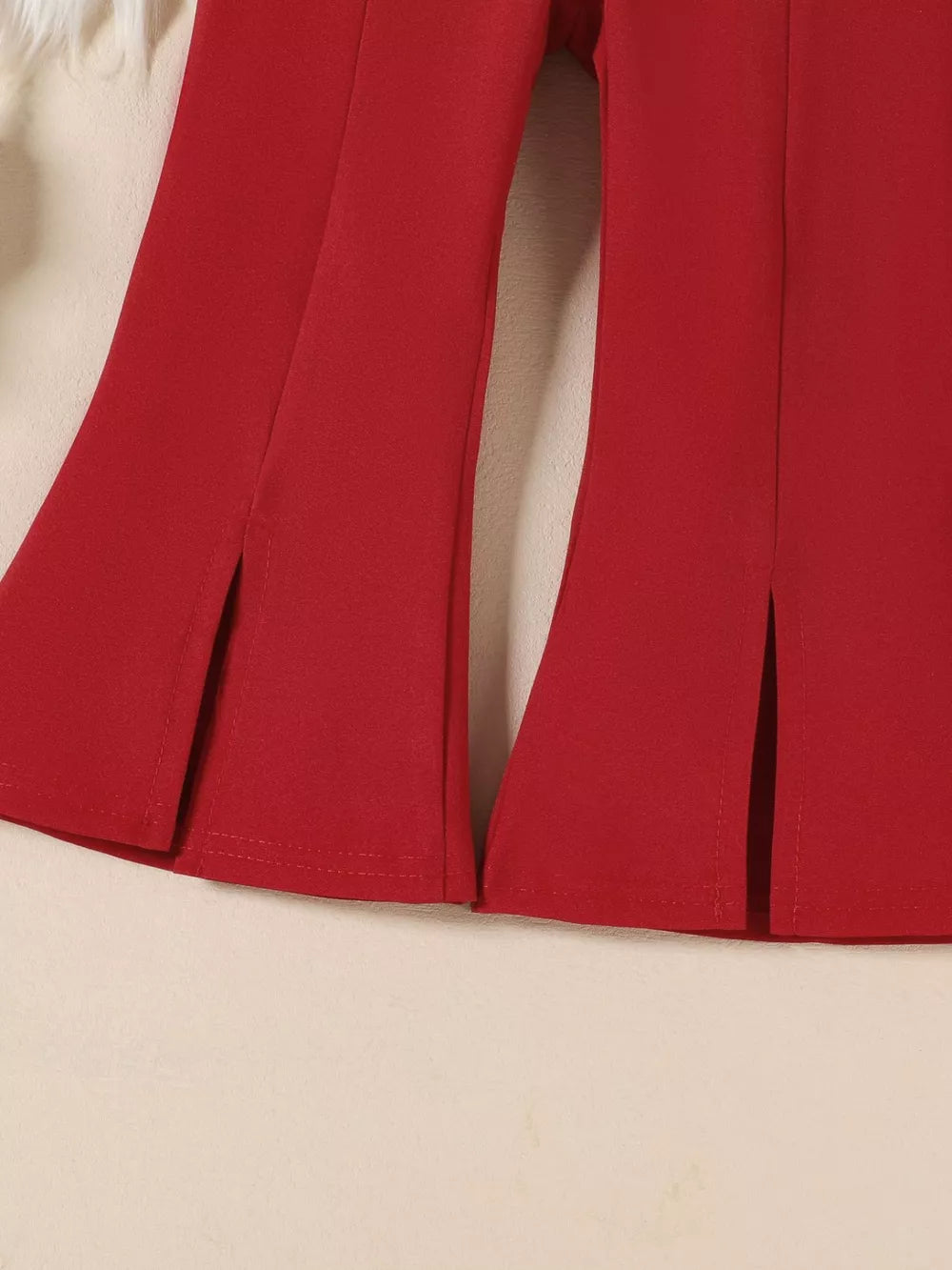 Wine red flare pants with side slits and ruffled trim detail