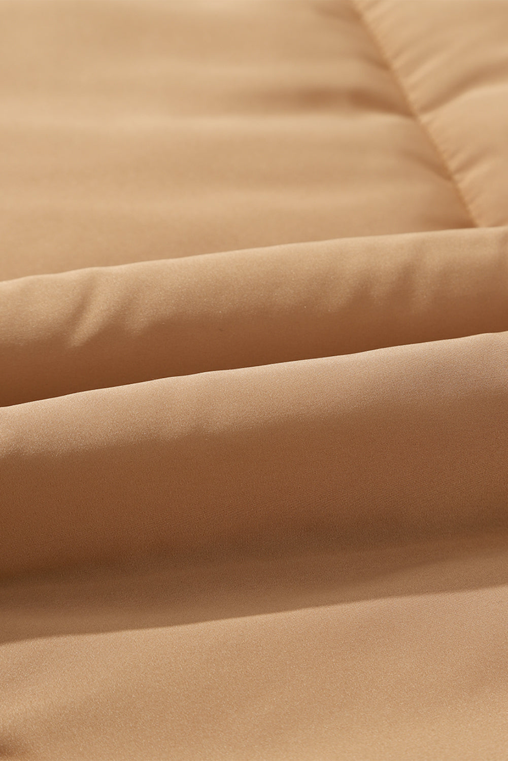 Tan padded sleeveless hooded vest with quilted texture and visible stitching detail.