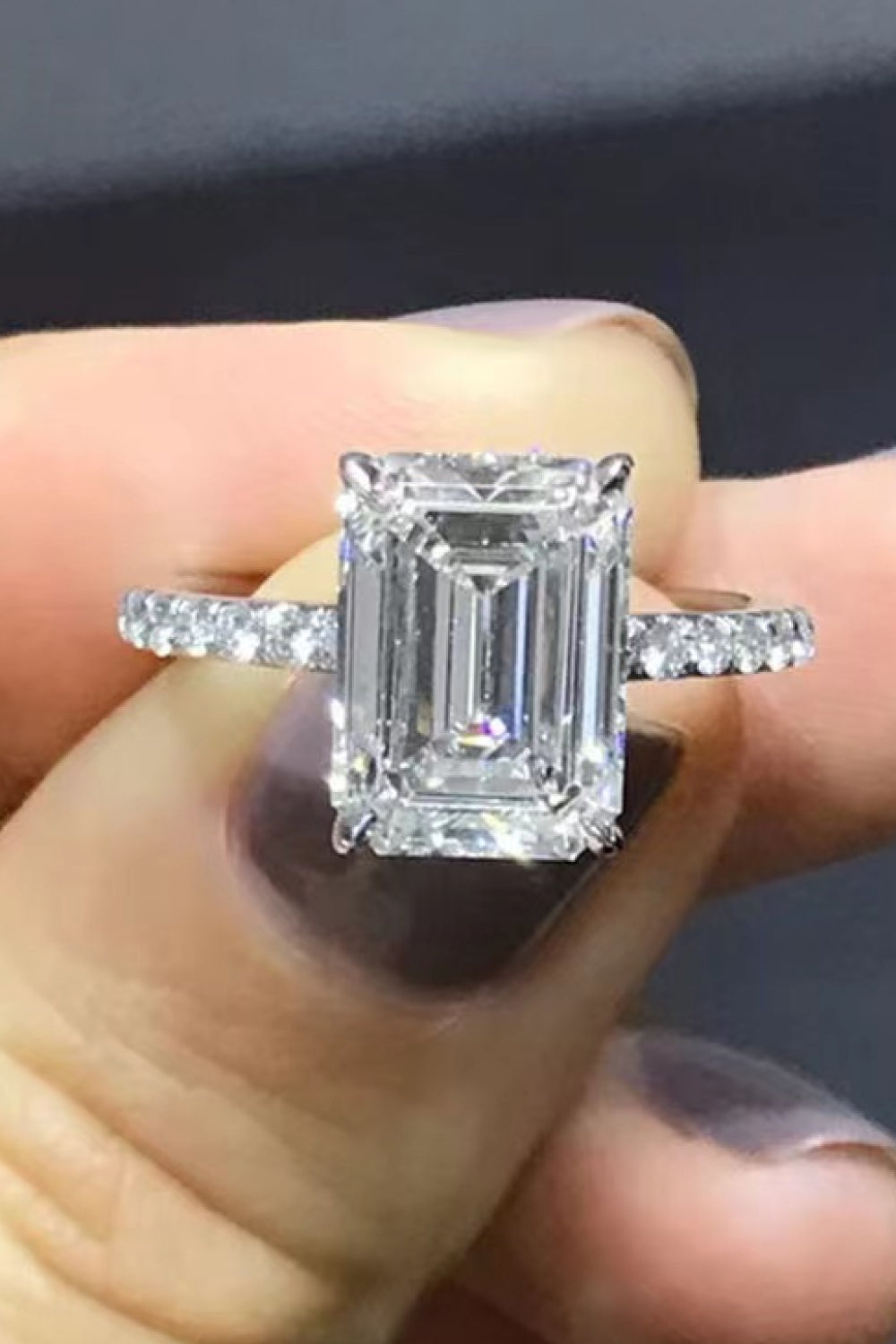 Sparkle Luxe Moissanite Halo Ring in silver with emerald-cut center stone and diamond band.