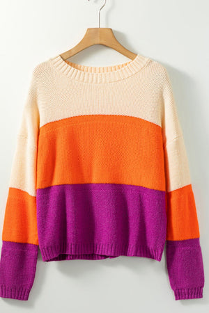 Colorblock ribbed knit pullover sweater with crew neck and long sleeves in cream, orange, and purple stripes.