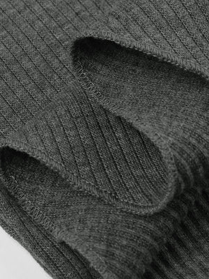 Dark gray ribbed knit asymmetrical top with a cropped cut and visible stitching detail.