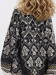 Geometric jacquard knit open cardigan in black with a diamond pattern.