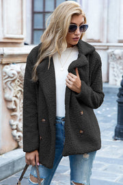 Black teddy pea coat with double-breasted buttons and notched lapels.