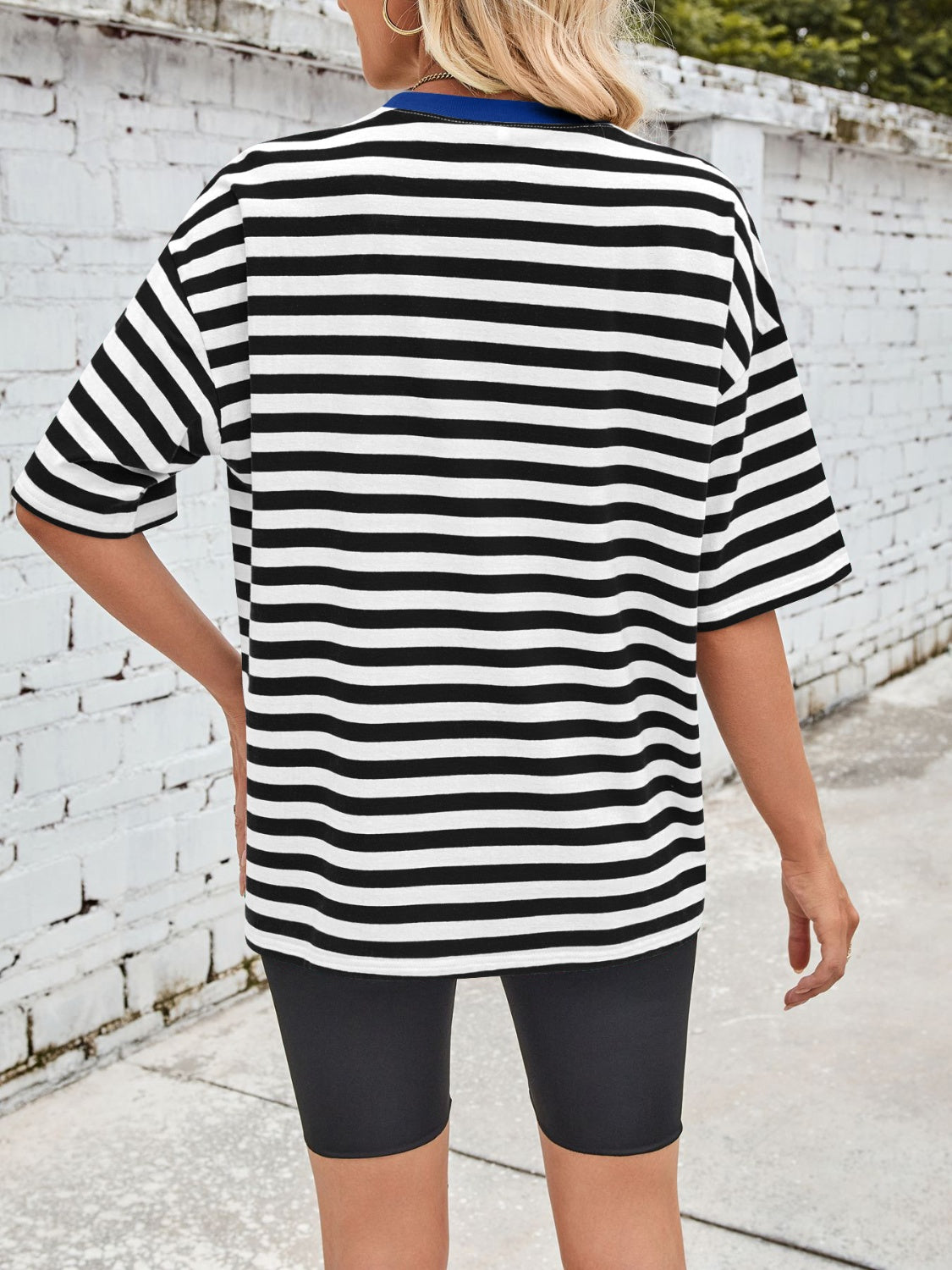 Relaxed fit black and white striped tee with contrast blue neckline.