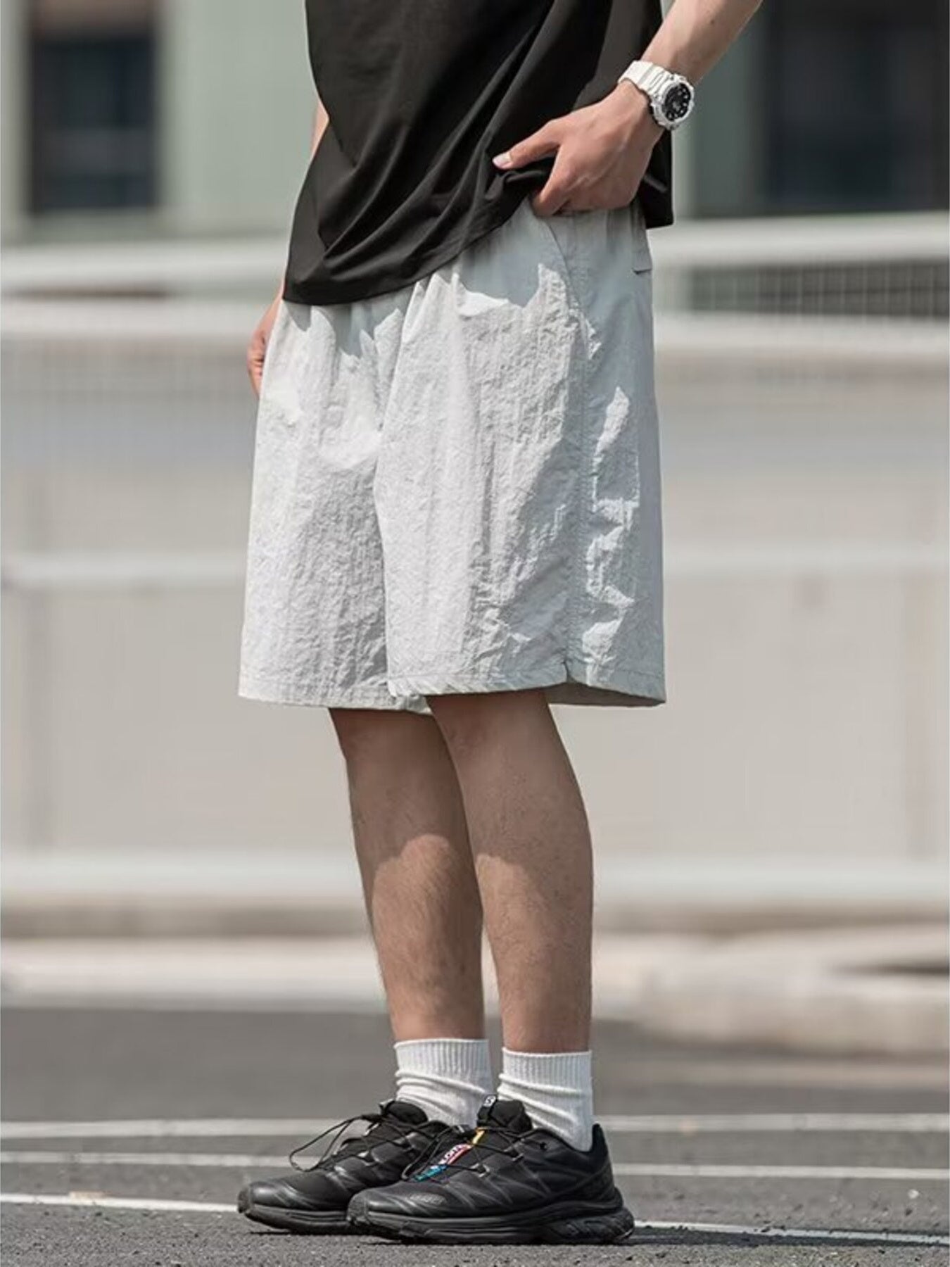 Men's light gray textured drawstring shorts with pockets.
