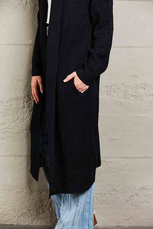 Black textured knit maxi cardigan with pockets and a relaxed fit.