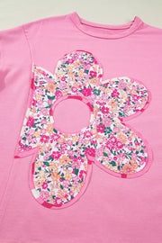 Pink cotton tunic t-shirt with a large floral patch applique and striped trim.