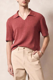 Textured ribbed knit polo shirt in orange-red with Johnny collar and short sleeves.